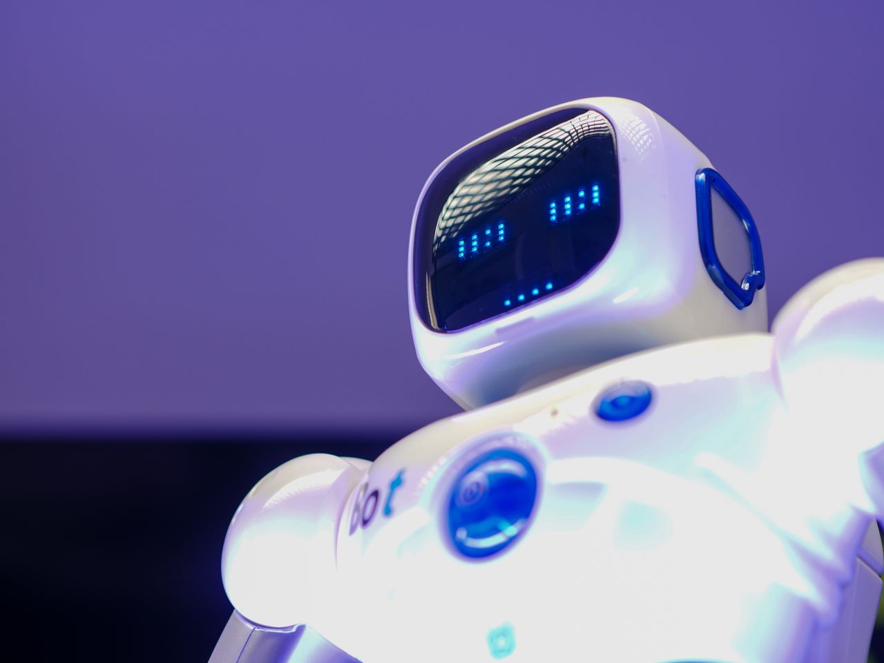 services-01 A modern humanoid robot with digital face and luminescent screen, symbolizing innovation in technology.